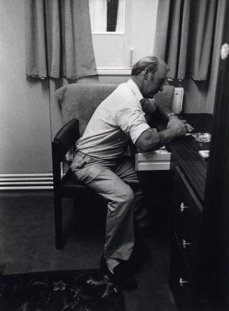Man at A Desk, Black & White Photograph by Fay Godwin