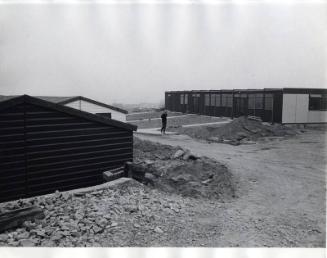 Man Walking on Building Site, Black & White Photograph by Fay Godwin