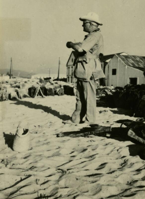 James McBey standing on beach (Photographs of James McBey)