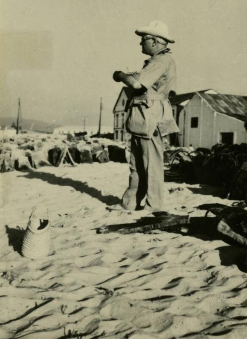 James McBey standing on beach (Photographs of James McBey)