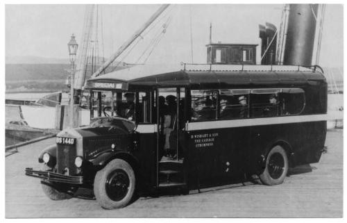 photograph taken at Warehouse Pier, Stromness, with special bus in foreground and parts of 'St …