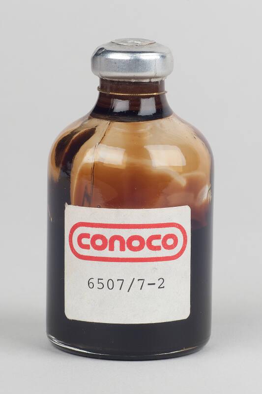 Glass bottle containing a sample of oil from Conoco, 6507/7-2 (plugged and abandoned well)