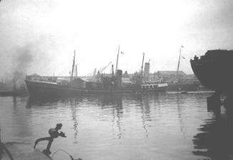 film negative showing an unidentified trawler, the stern of Dame Caroline Haslett is visible on…