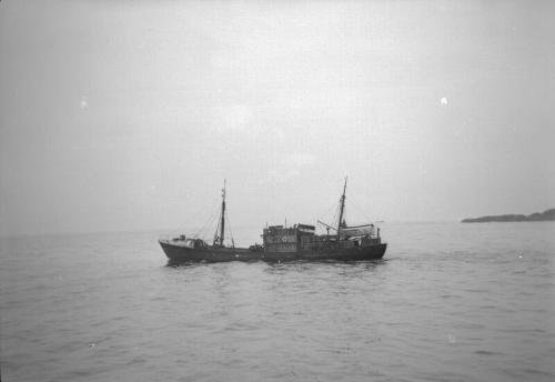 film negative showing an unidentified trawler in silhouette