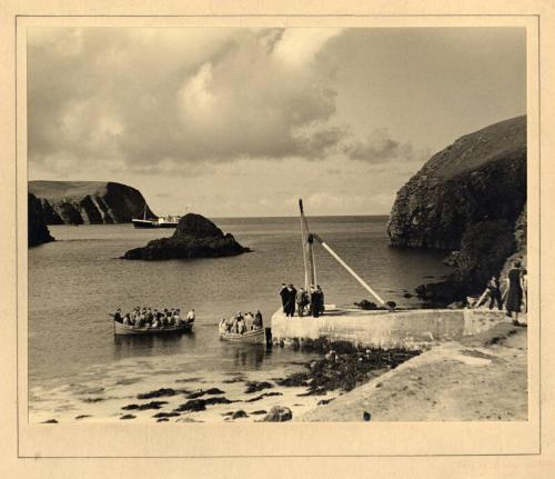 Photograph showing passengers being transferred ashore in small boats, from Earl of Zetland II …