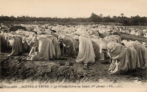 Ouside of scene of large group of men bowing (La Grande Priere au Desert) 