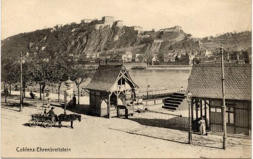 Coblenz - View of horse and cart by riverside buildings with village in background (Ehrenbreits…