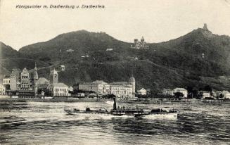 Germany - Boat on river with town and mountain in the background 