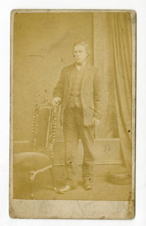 Standing young man with narrow bow tie