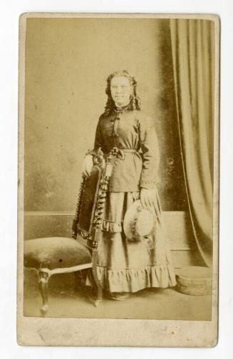 Standing young woman with ringlets