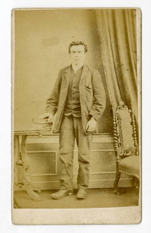 Curly haired young man, standing