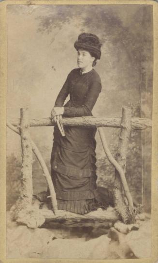 Young woman on rustic bridge