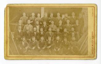 Group of men in an outdoor setting (wood yard)