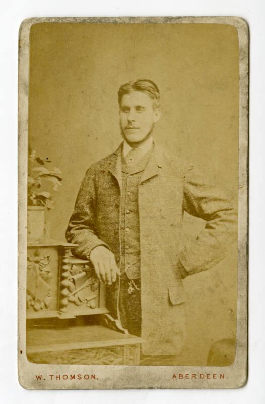 Three-quarter portrait of young man in long jacket