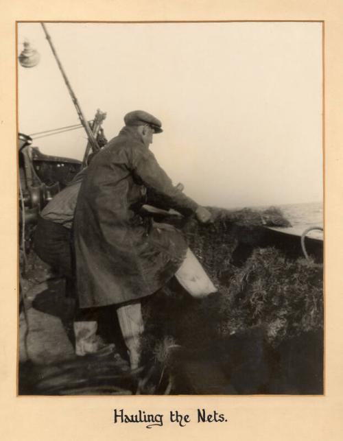 Mounted photograph entitled "hauling the nets" by frank nicol