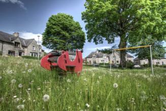 Digital photograph of an overgrown playground