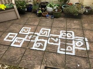 Digital photograph showing hopscotch in a small garden