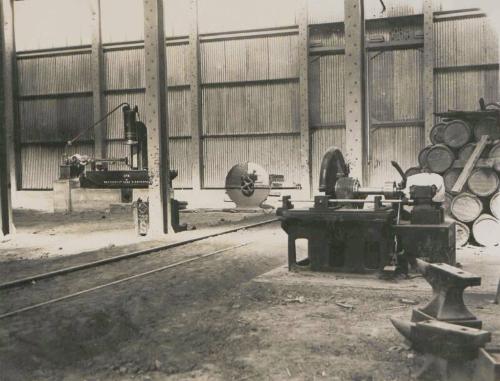 76. Huambo. Portion of blacksmiths shop - spring testing machine left of photo