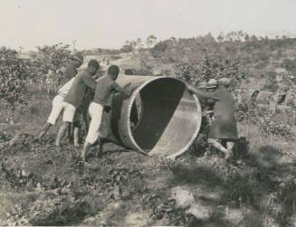 89. Quando Dam. Rolling down a section for the pipe line.