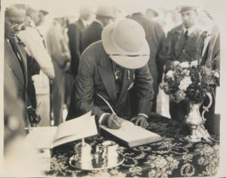 108. Sir Robert Williams signs the visitors’ book after the Opening Ceremony