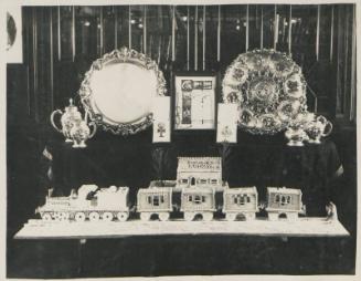 113. Antique Plate presented to Sir Robert Williams by Employees of the Benguela Railway. Model of Benguela Railway made by the Chief Baker on 'Balmoral Castle'
