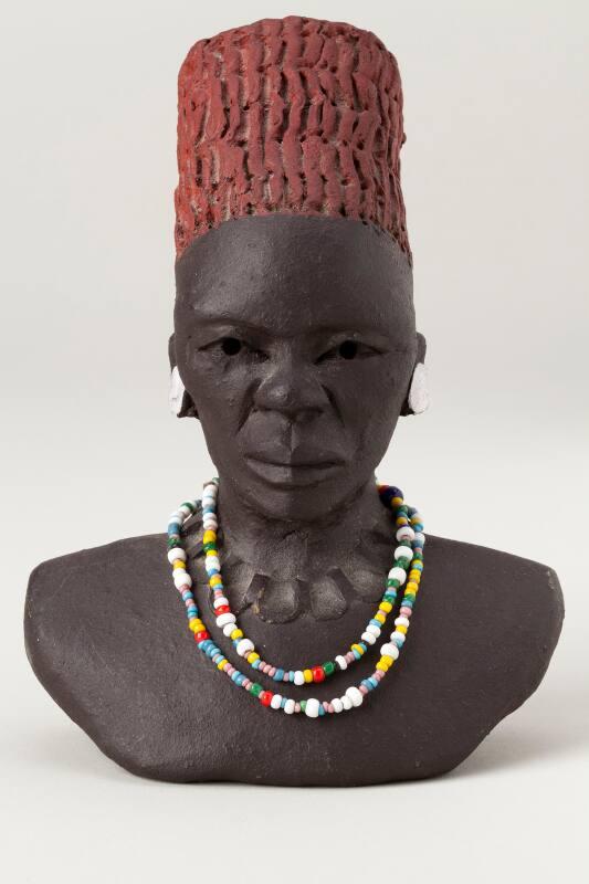 Zulu head wearing bead necklace