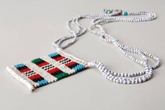 Three strand bead necklace with bead plaque