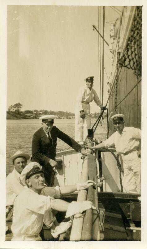 Photograph of five men in small boat