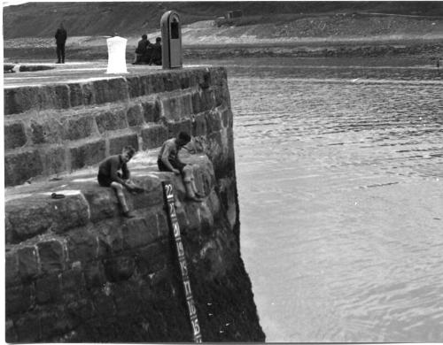 Black and white photograph showing Aberdeen Harbour in the 1930s, boys on the quayside