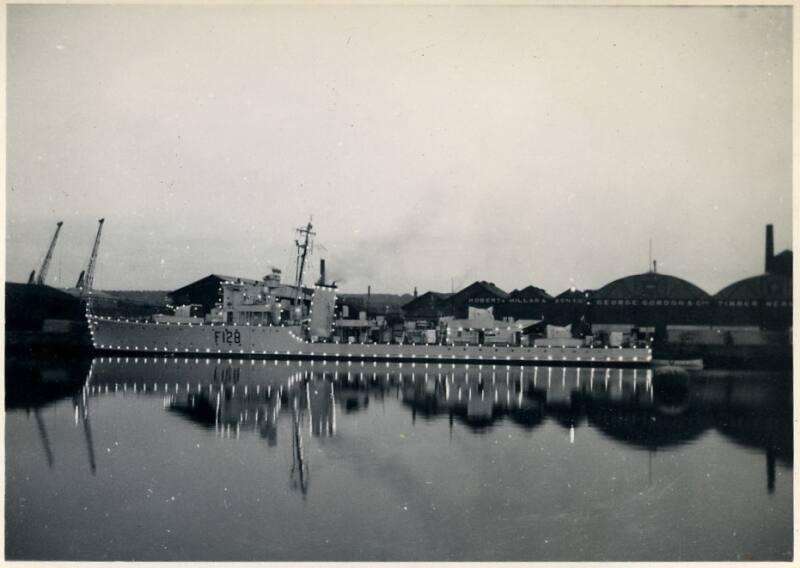 Black and White Photograph in album of Royal Naval vessel, possibly frigate in harbour