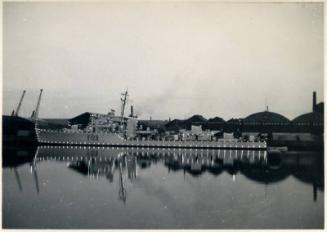 Black and White Photograph in album of Royal Naval vessel, possibly frigate in harbour