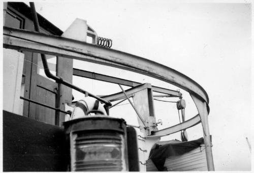 Black and White Photograph in album: external close up of vessel's wheelhouse