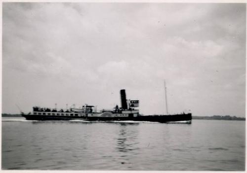Black and White Photograph in album of paddle steamer under way