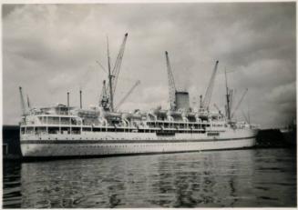Black and White Photograph in album of docked passenger ship possibly Dilwara