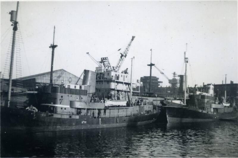 Black and White Photograph in album of ships alongside Hall Russell's shipyard