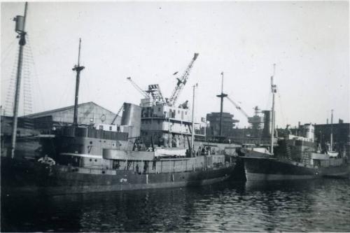 Black and White Photograph in album of ships alongside Hall Russell's shipyard