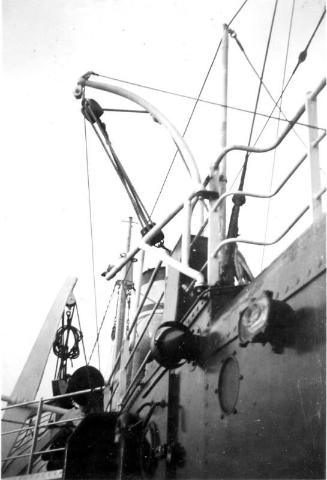 Black and White Photograph in album onboard ship close up of derricks and railings