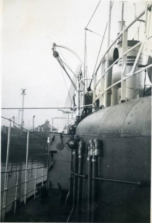 Black and White Photograph in album onboard ship- close up of railings and pipes