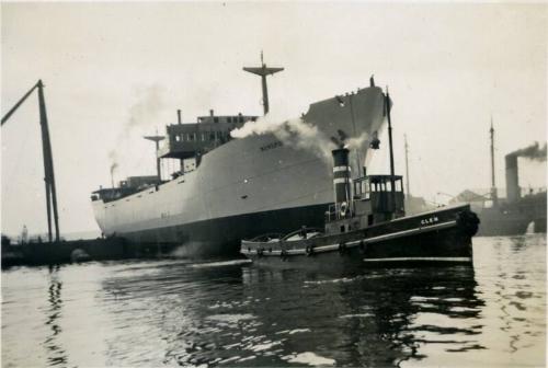 Black and White Photograph in album of cargo ship 'Nordpol' with tug 'Glen'