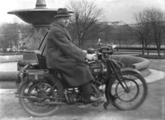Man on Motorcyle in Duthie Park with Harper's Engineering Works in Background