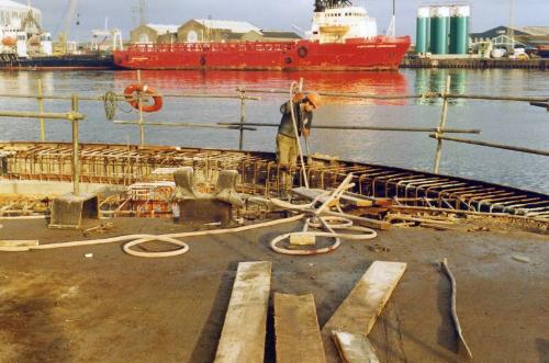 Colour Photograph Showing New Quay Being Constructed At Point Law.Osv 'northern Commander' In Backgroun