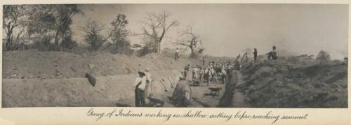 Gang of Indians working on shallow cutting before reaching summit