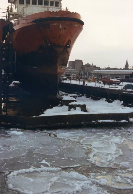 Colour Photograph Showing Vessel In Dry Dock With The Harbour Frozen Over