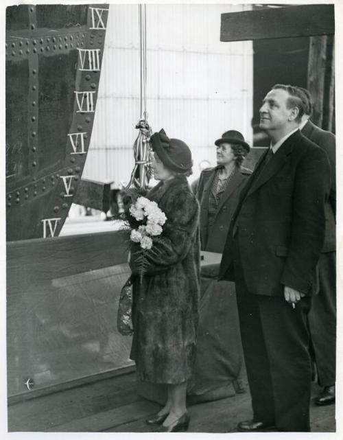 Black and white photograph showing smashing the bottle at the launch of 'fulham x'