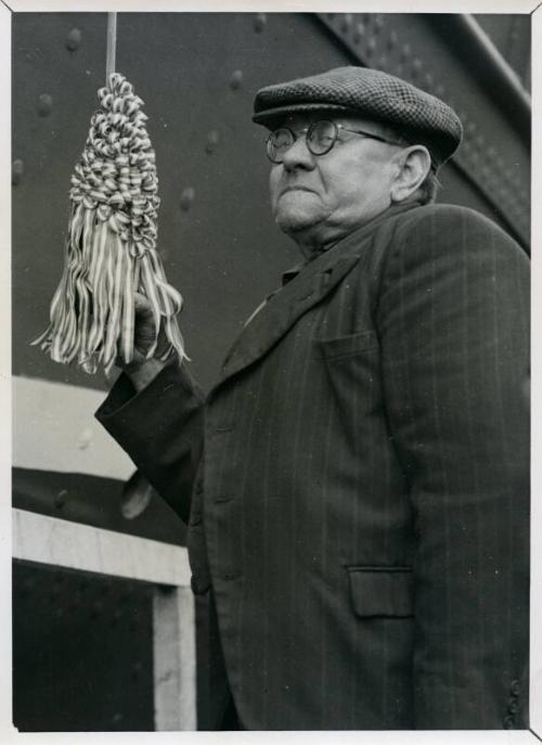 Photograph showing John Lewis employee about to launch trawler Summerlee