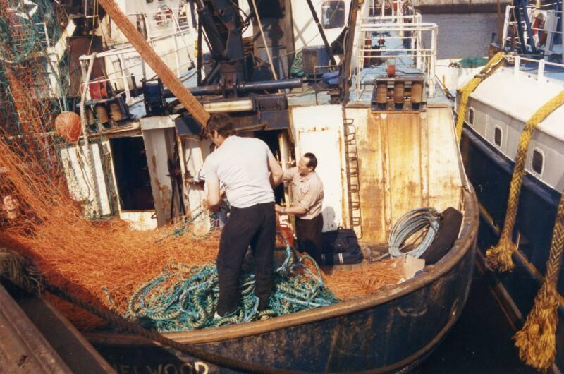 Colour Photograph Showing Fishermen Sorting Nets On Deck At Aberdeen Harbour