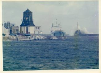 Colour Photograph Showing Round House And Harbour Entrance Withsupply Vessels Entering And Big Wave