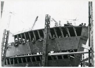 Photograph showing shipyard staff at the launch of an unidentified vessel